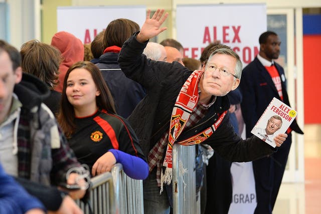 An enthusiastic fan queues up at a signing of Sir Alex Ferguson's autobiography in Manchester