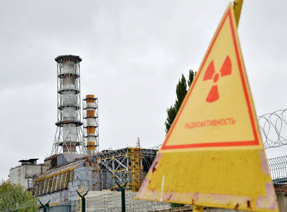 A view of a radioactive sign near a shelter and containment area built over the destroyed 4th block of Chernobyl's old nuclear power plant