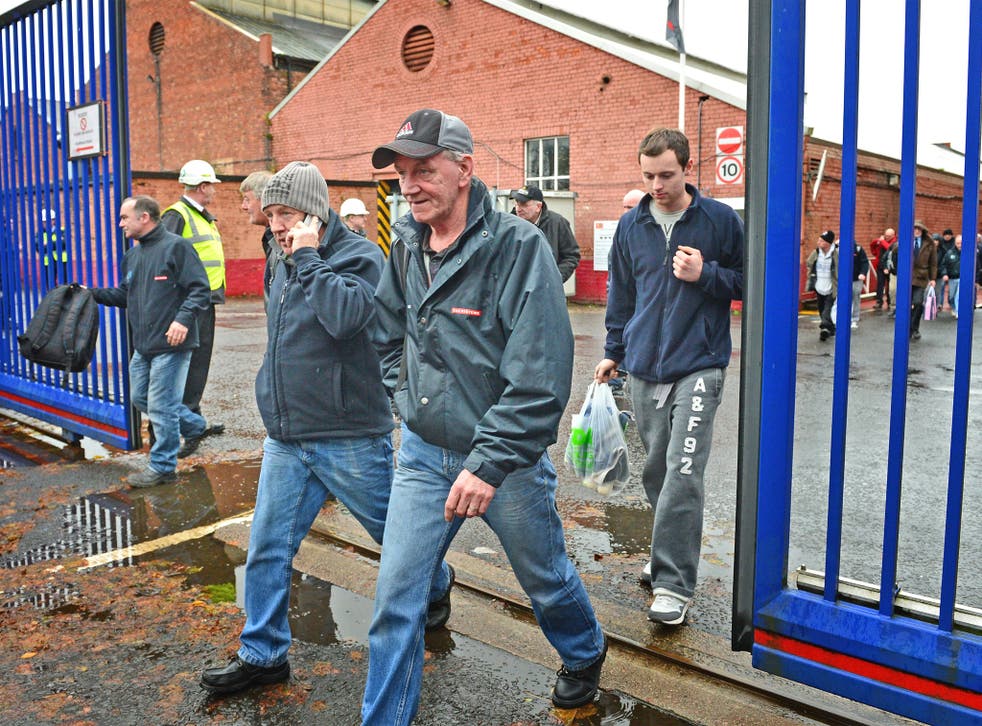 Shipyard workers leave the BAE systems yard in Govan following the announcement that the company will be cutting jobs