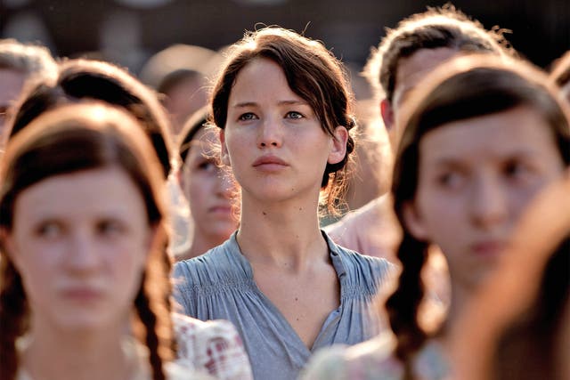 Jennifer Lawrence, here pictured as Katniss Everdeen in The Hunger Games, works like a 'slave' according to Russell