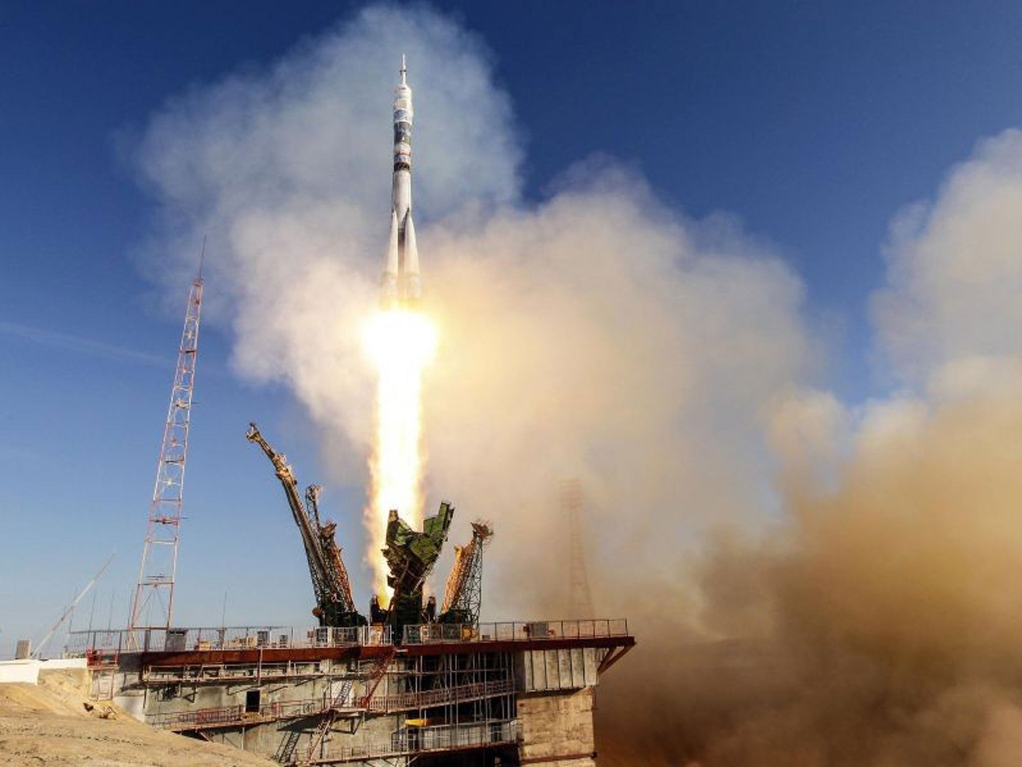 The Soyuz TMA-11M spacecraft decorated with the 2014 Sochi Winter Olympic Games logo and a blue-and-white snowflake pattern, blasts off from the launch pad at the Baikonur cosmodrome