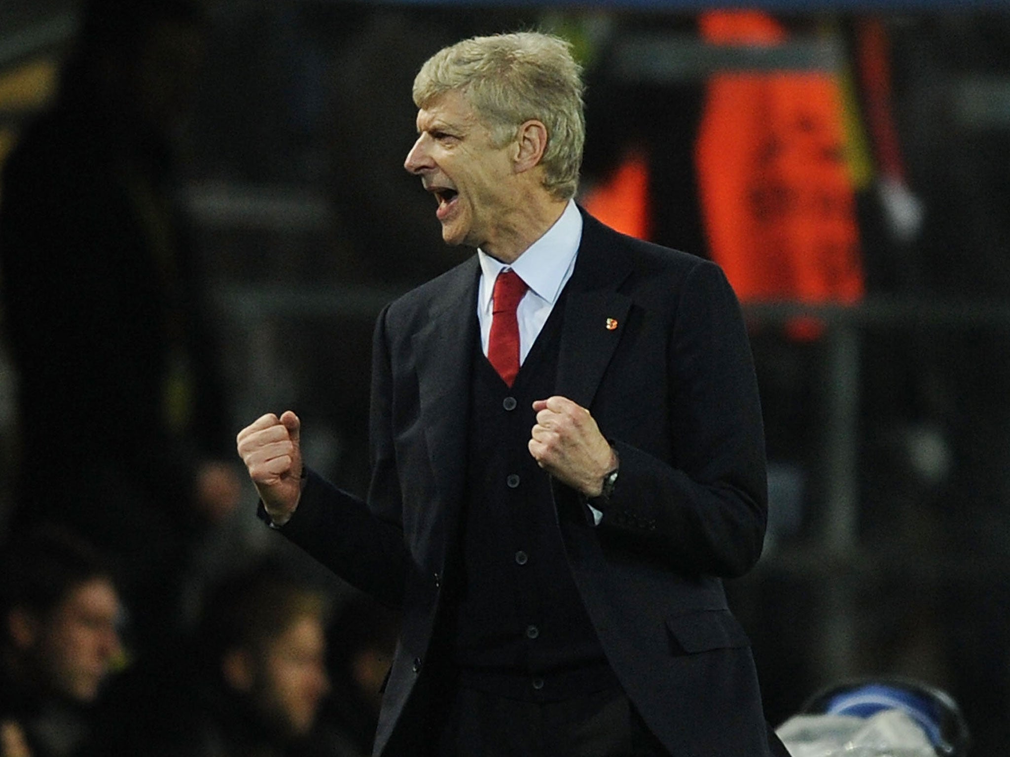 Arsenal manager Arsene Wenger clebrates after Aaron Ramsey scores against Borussia Dortmund