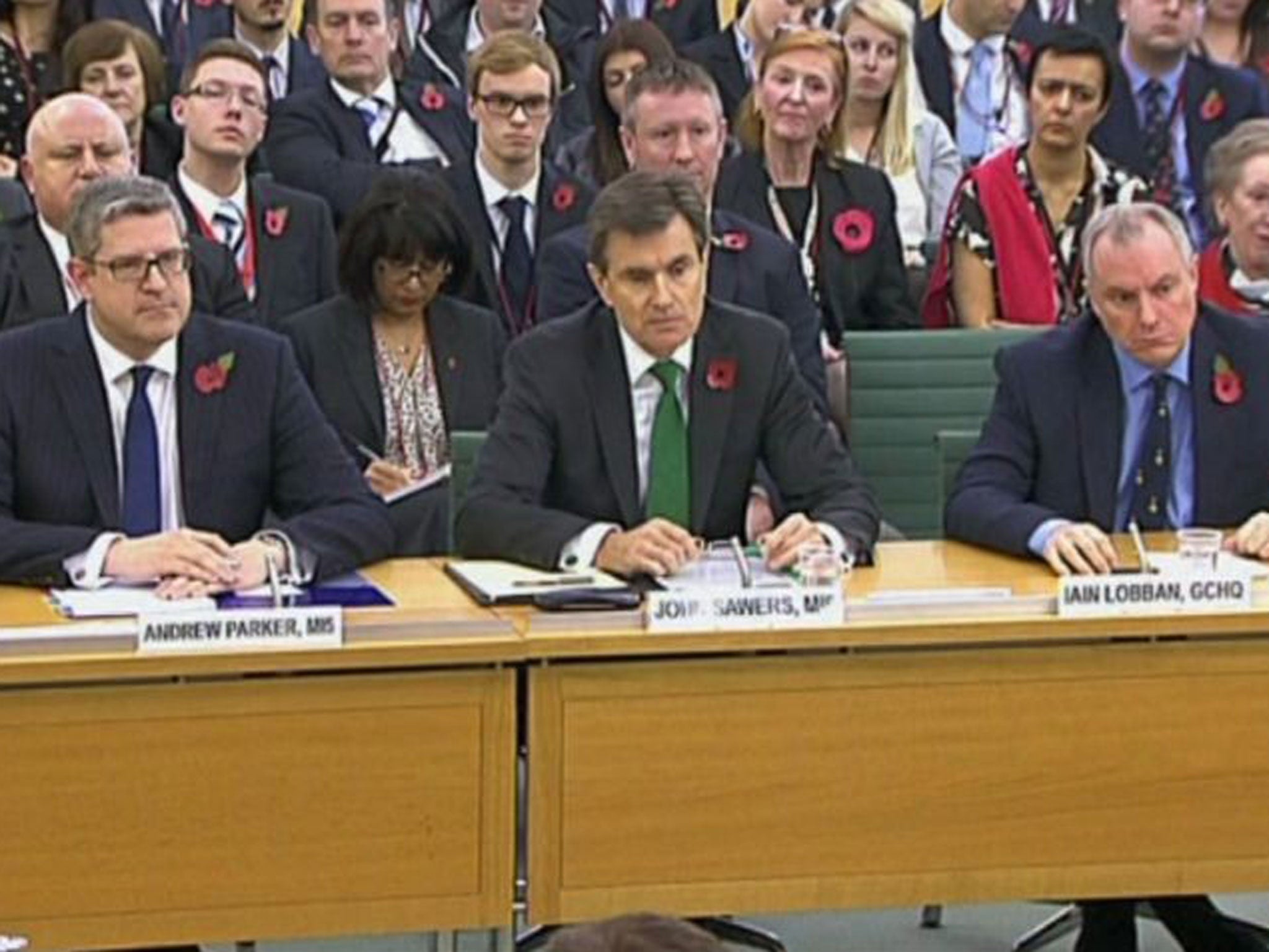 From left, Andrew Parker head of Britain's domestic security agency MI5, John Sawers head of Britain's foreign spy service MI6 and Iain Lobban director of electronic surveillance agency GCHQ, as they take questions from Parliament's Intelligence and Security Committee, questioned on the work of their agencies, their current priorities and threats to the UK