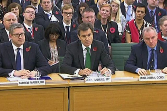 From left, Andrew Parker head of Britain's domestic security agency MI5, John Sawers head of Britain's foreign spy service MI6 and Iain Lobban director of electronic surveillance agency GCHQ, as they take questions from Parliament's Intelligence and Security Committee, questioned on the work of their agencies, their current priorities and threats to the UK