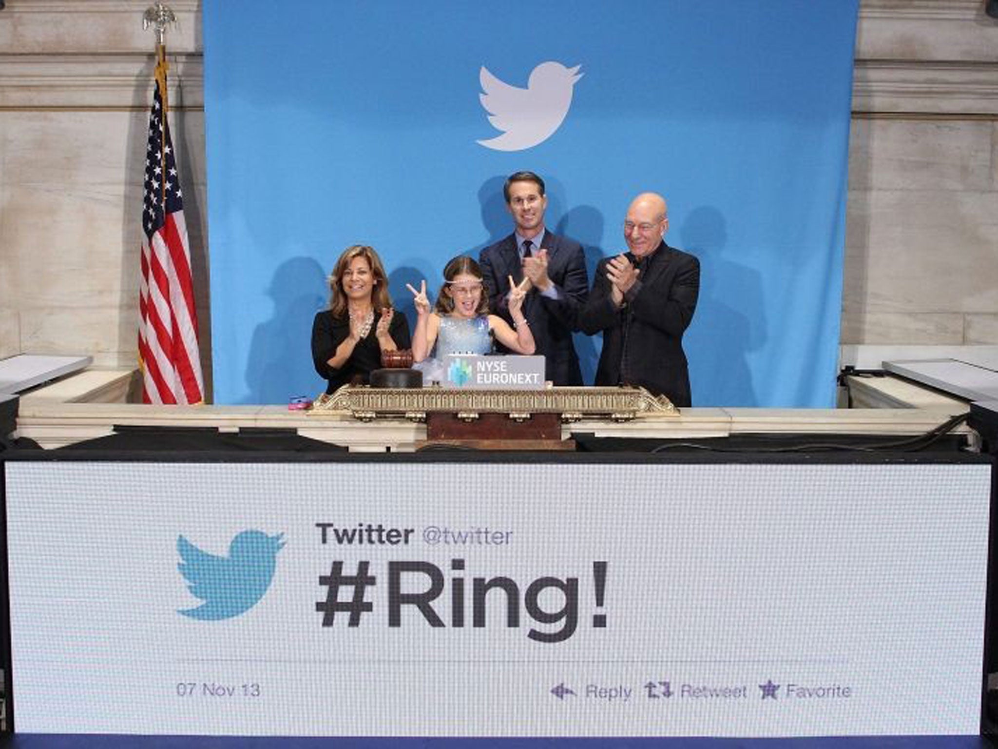 British actor Sir Patrick Stewart (R), flanked by Vivienne Harr (2-L), Boston police officer Cheryl Fiandaca (L) and Twitter co-founder Evan Williams (2-R) at the ringing of the opening bell to mark Twitter's highly anticipated initial public offering (IPO), New York
