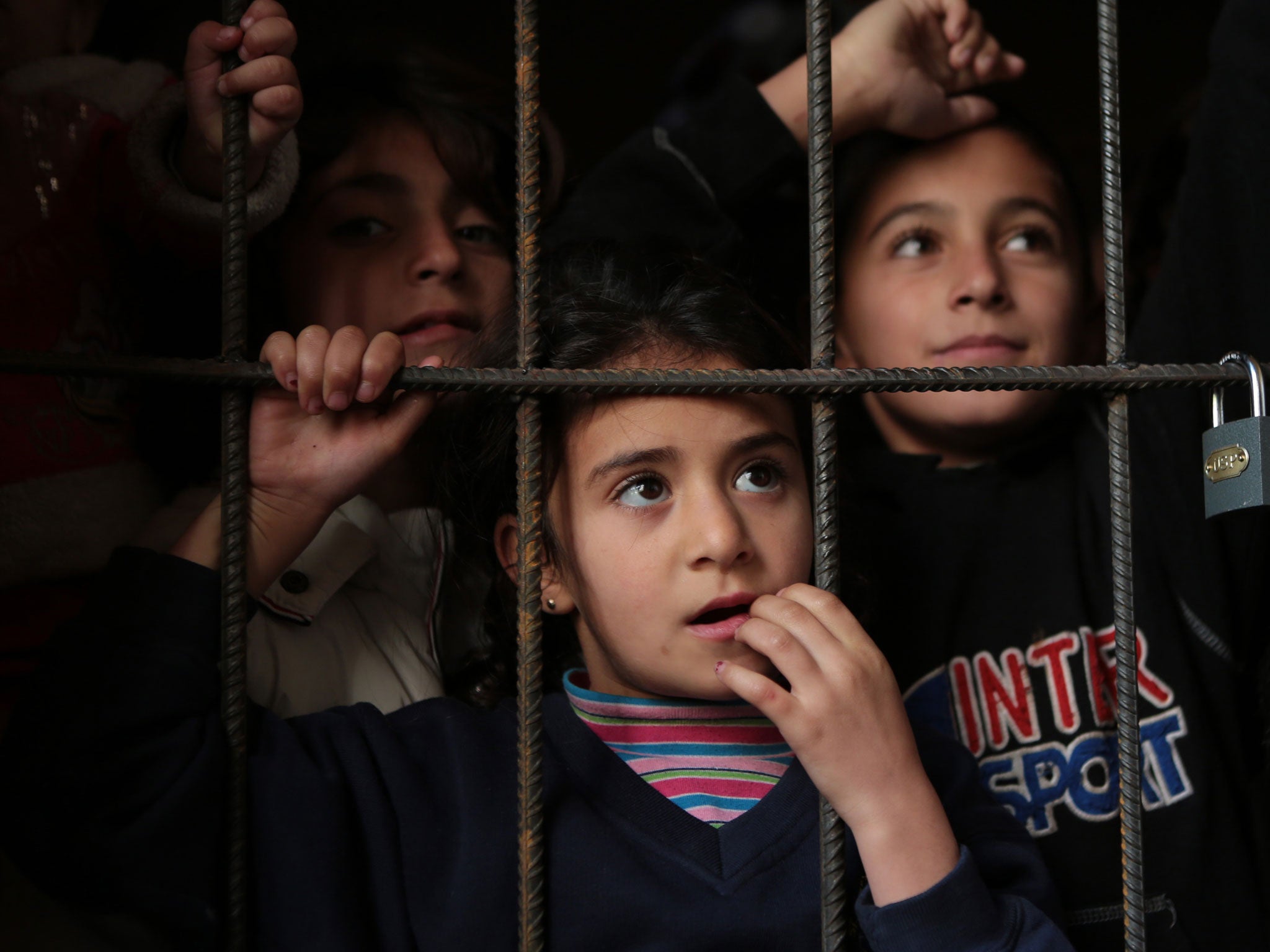 Refugee Syrian children wait for a medical check up in a corridor of newly opened refugee camp