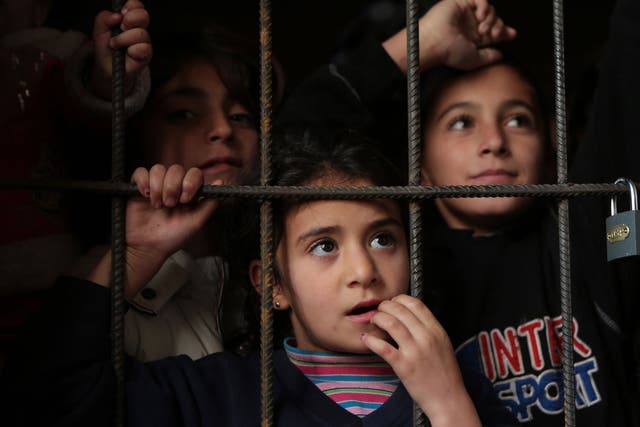 Refugee Syrian children wait for a medical check up in a corridor of newly opened refugee camp