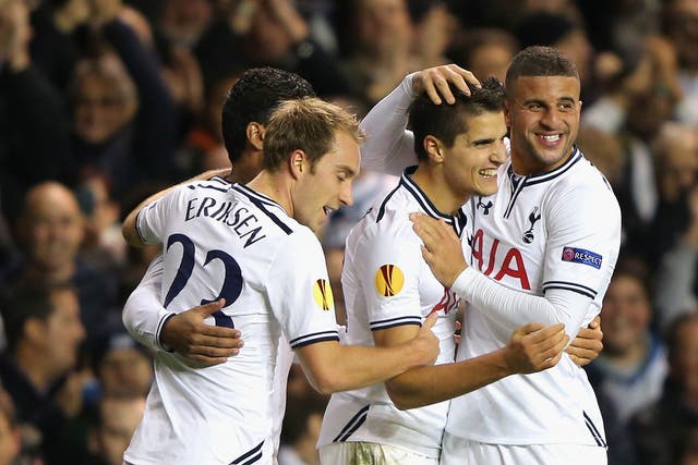 Erik Lamela, who scored the first and made the second, is mobbed 
