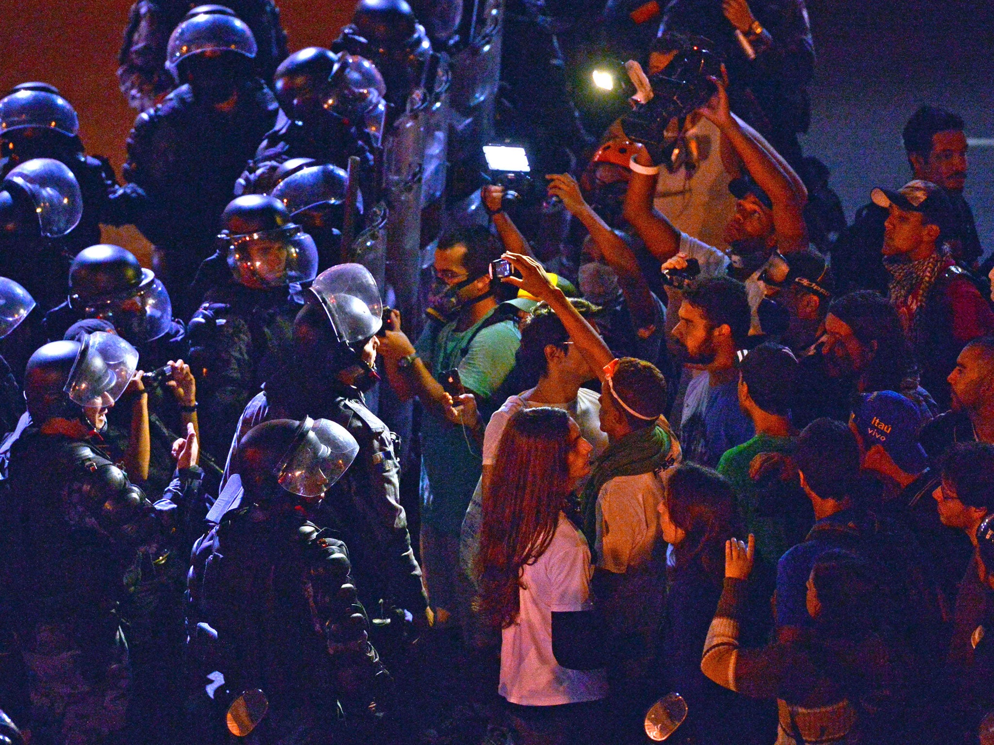Riot police and protesters face-off near the Maracana Stadium during the Confederations Cup