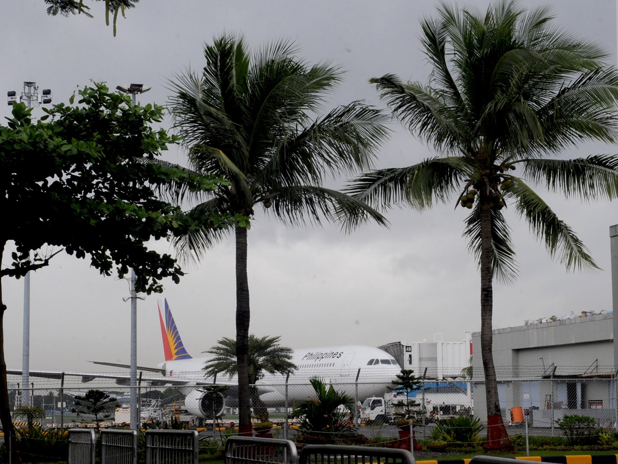 A Philippine Airlines jet stands on the tarmac at Manila's International airport as one of the most intense typhoons ever recorded tore into the Philippines