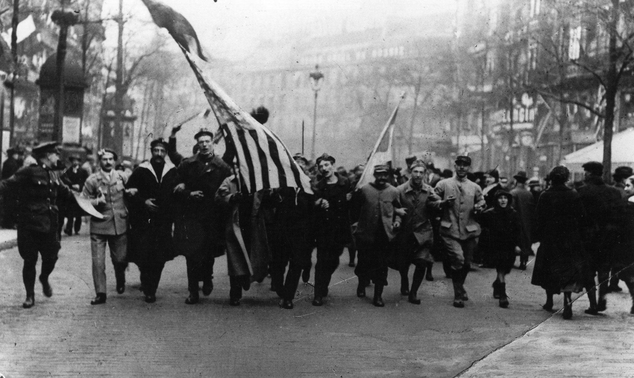 Soldiers, sailors and civilians celebrate Armistice Day in 1918