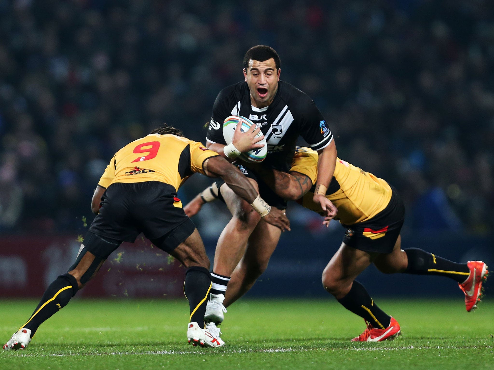 New Zealand's Alex Glenn, centre, is tackled by Papua New Guineas Dion Aiye, right, and Charlie Wabo