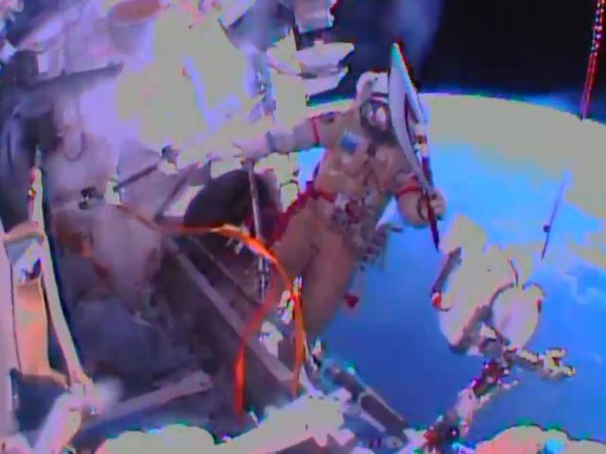 In this image obtained from Nasa TV, Cosmonaut Oleg Kotov exits the International Space Station on November 9, 2013, with the Sochi 2014 Winter Olympic Games torch.