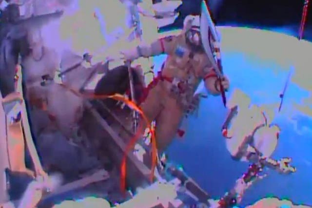 In this image obtained from Nasa TV, Cosmonaut Oleg Kotov exits the International Space Station on November 9, 2013, with the Sochi 2014 Winter Olympic Games torch. 