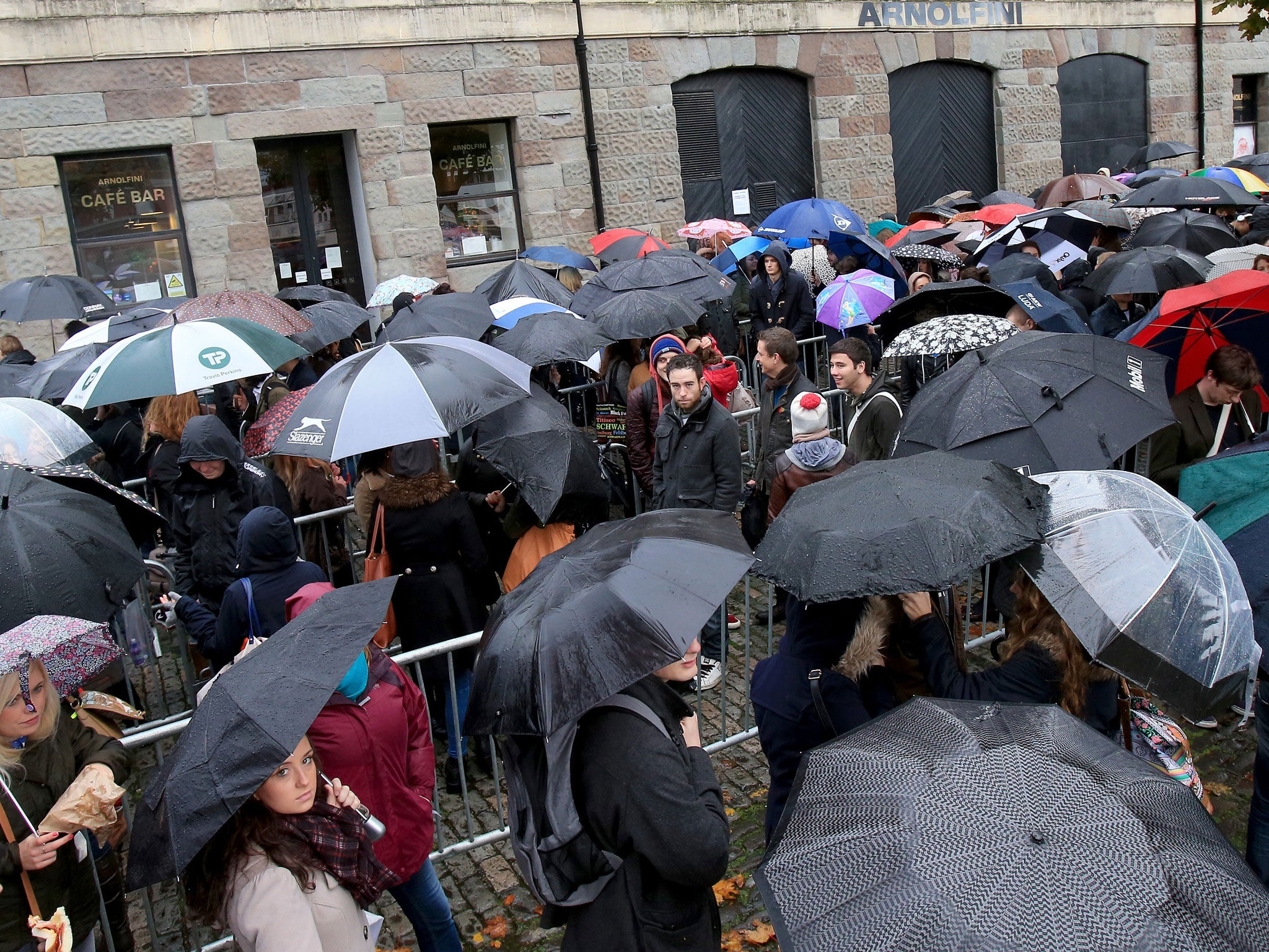 Hundreds of hopefuls shelter under umbrellas as they queue in the rain outside the Bristol Arnolfini art centre for an open audition for two lead roles in the next Star Wars film