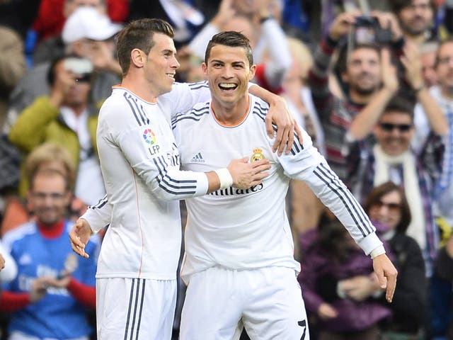 Real Madrid's Portuguese forward Cristiano Ronaldo (R) celebrates with Real Madrid's Welsh striker Gareth Bale
