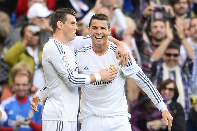 Real Madrid's Portuguese forward Cristiano Ronaldo (R) celebrates with Real Madrid's Welsh striker Gareth Bale