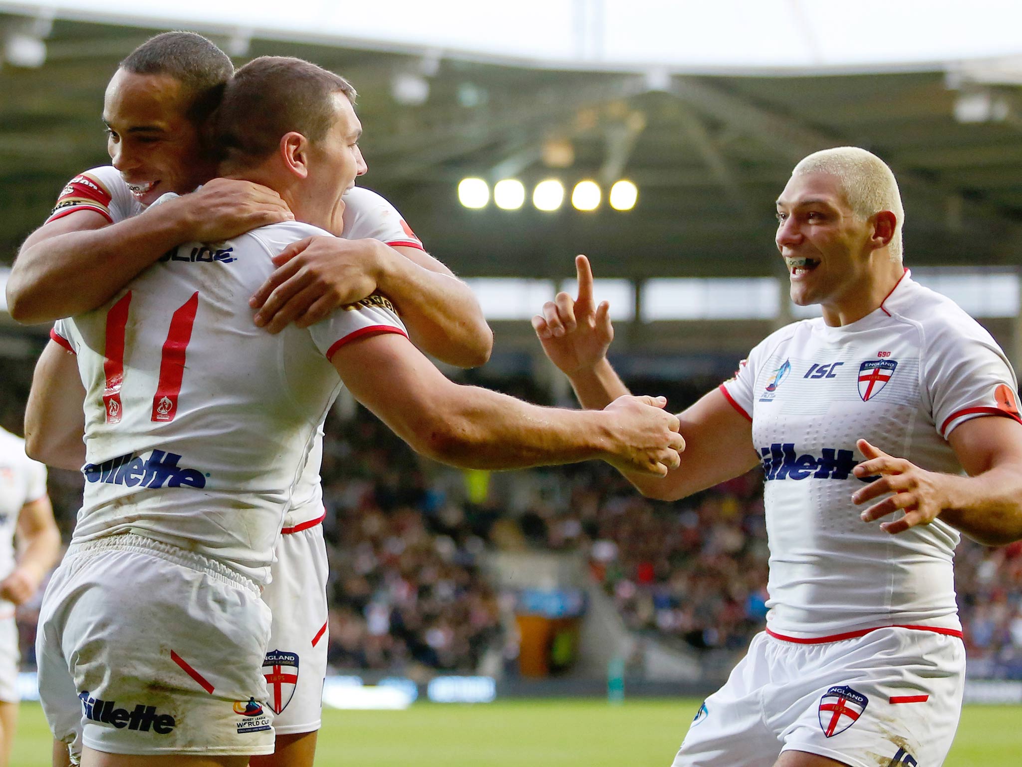 Brett Ferres (C) of England celebrates his try with team mates Leroy Cudjoe (L) and Ryan Hall during the Rugby League World Cup Group A match against Fiji