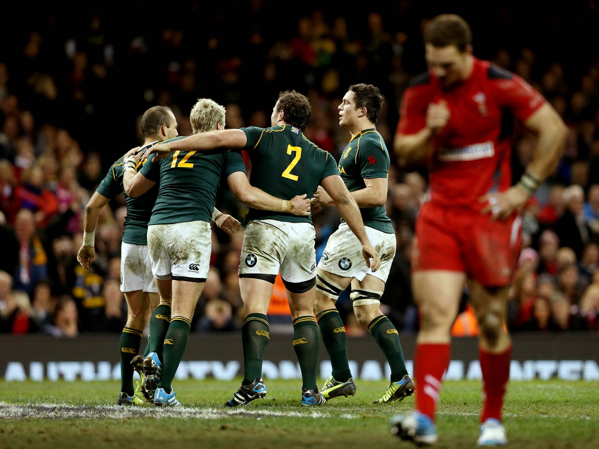 South Africa celebrate a try as George North of Wales looks dejected