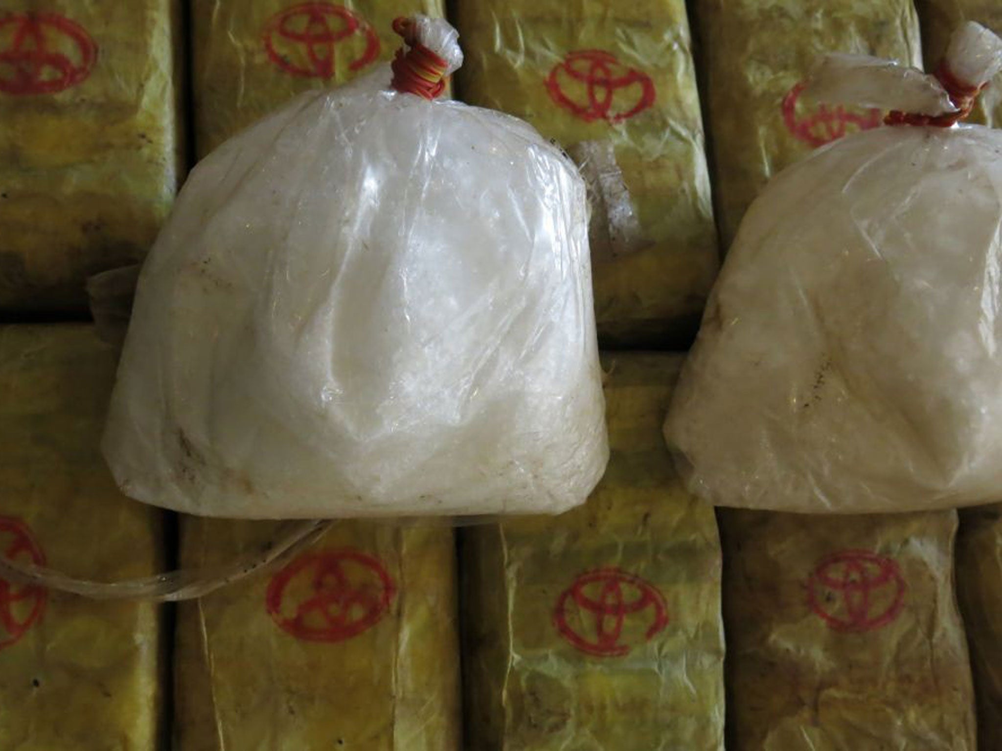 File photo showing two bags of crystal meth and packets of methamphetamine pills trafficked from Myanmar