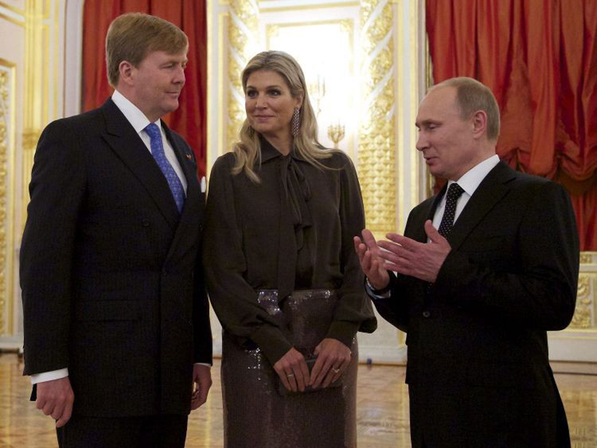 Russian President Vladimir Putin (R) speaking to King Willem-Alexander of the Netherlands (L) and Queen Maxima during their meeting in the Kremlin in Moscow, on Friday