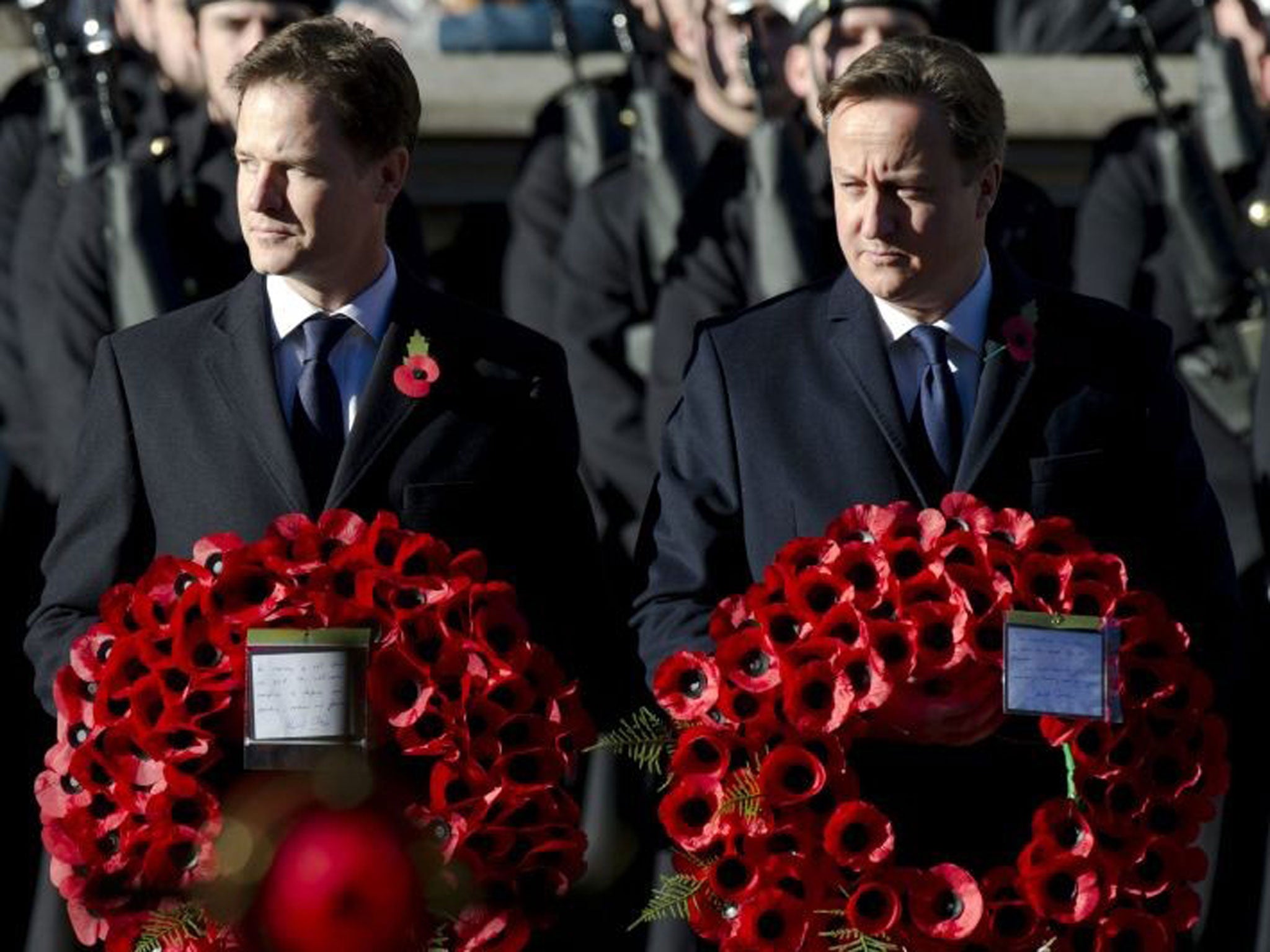 10 November 2013: Carrying their poppy-laden wreaths British Prime Minister, David Cameron and  Deputy Prime Minister Nick Clegg attend the Remembrance Day ceremonies at the Cenotaph on Whitehall