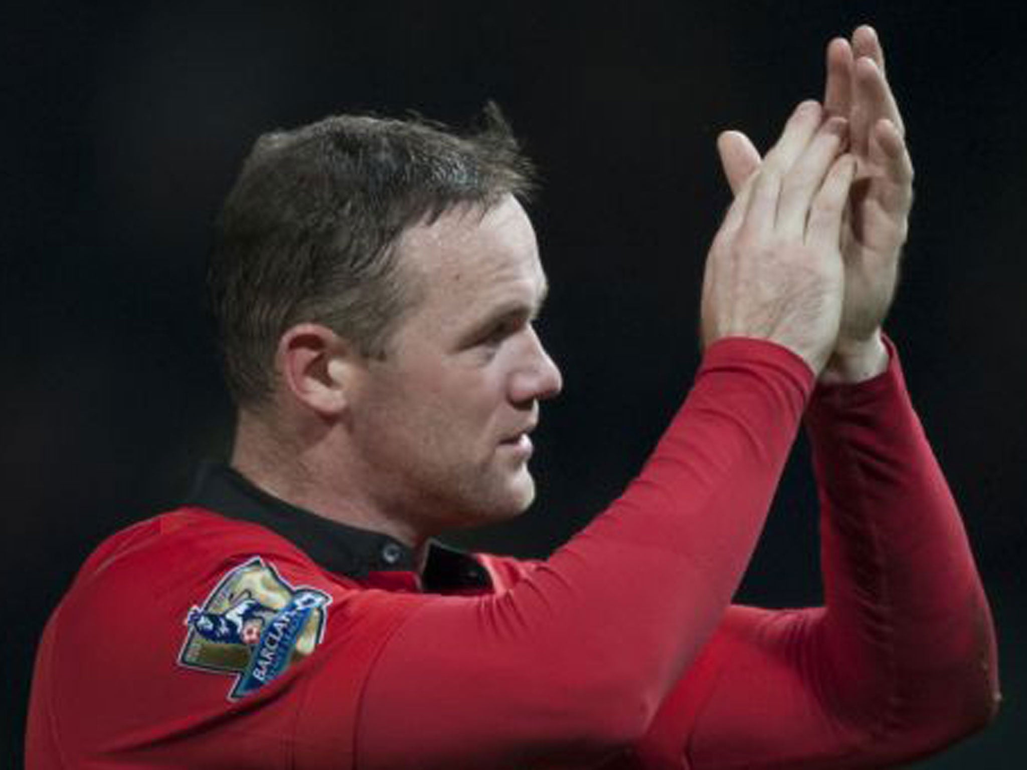 Wayne Rooney applauds the fans after the victory at Old Trafford