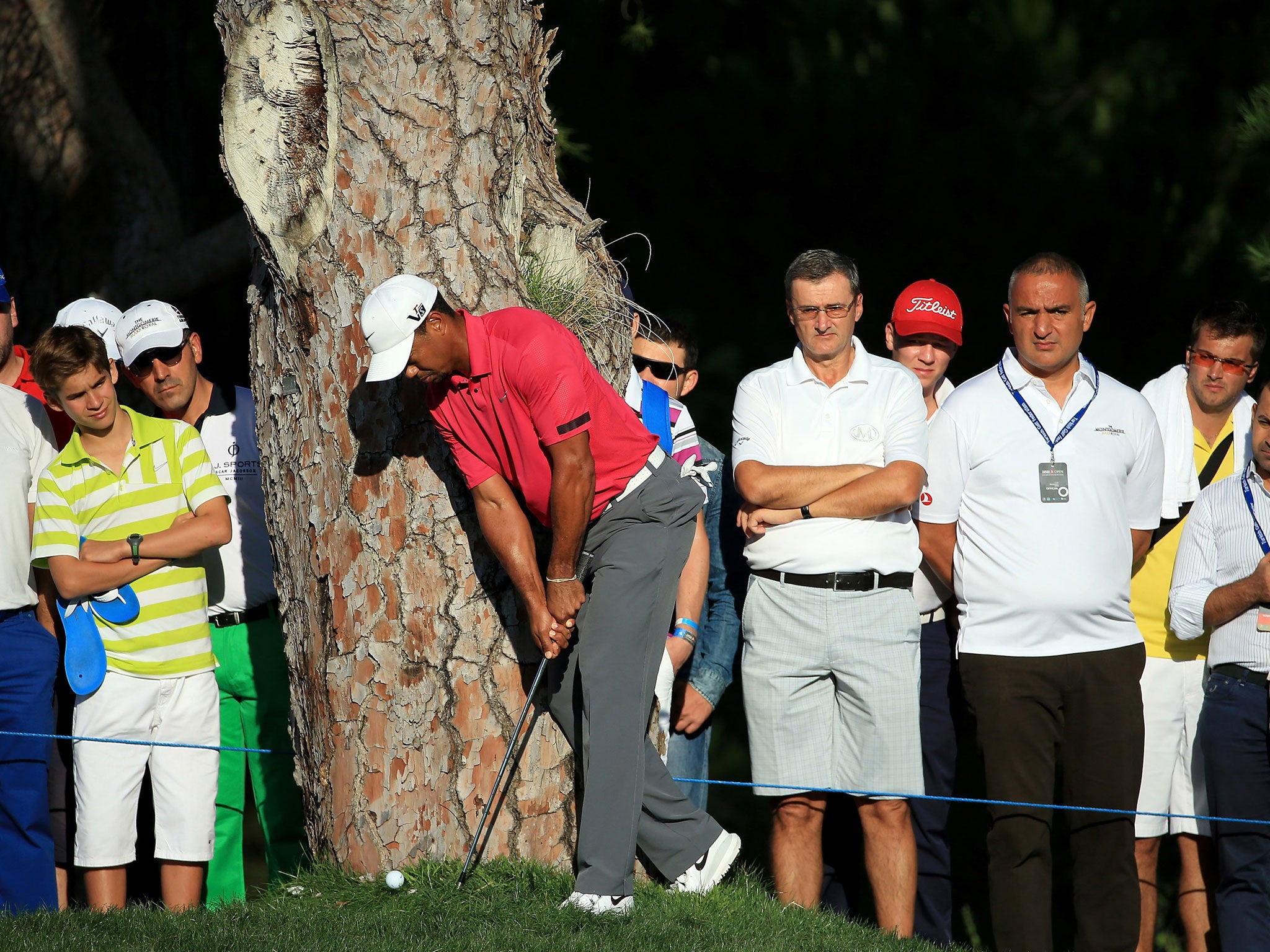 Tiger Woods boldly plays a wood from the trees at the Turkish Airlines Open
