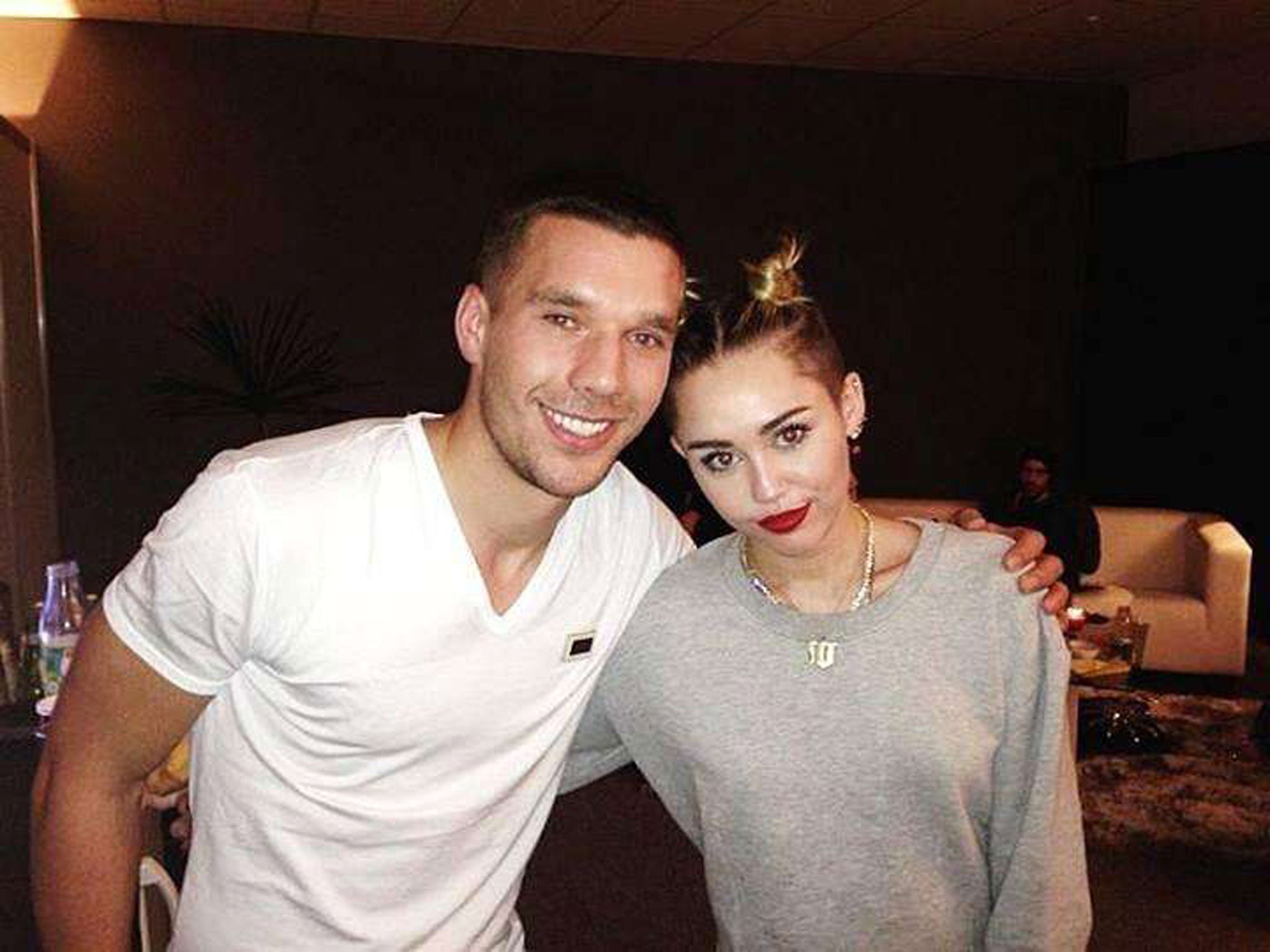 Lukas Podolski pictured with Miley Cyrus
