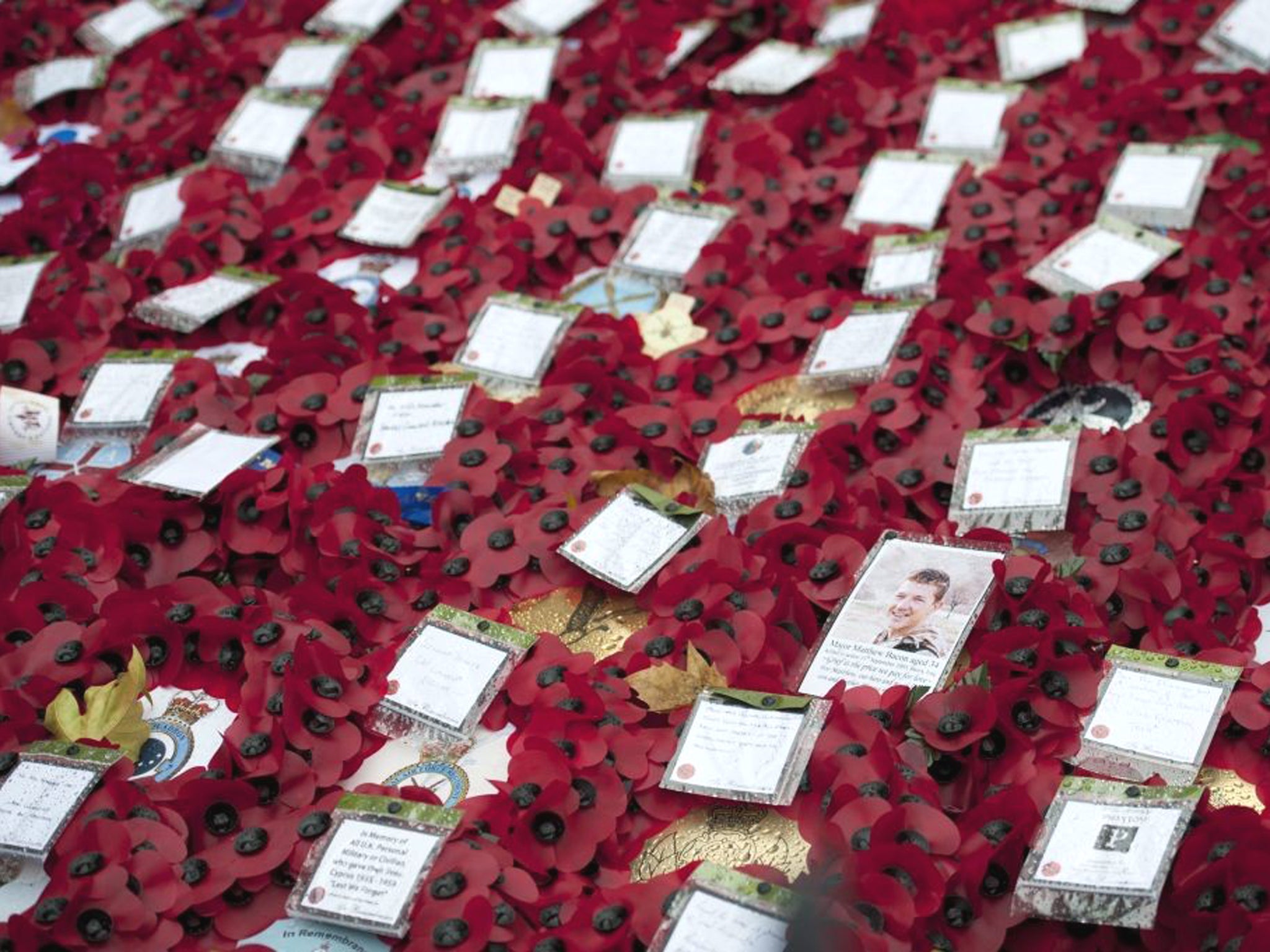 Poppy wreaths lie on the ground during a commemorative service on Armistice Day at the Cenotaph in central London
