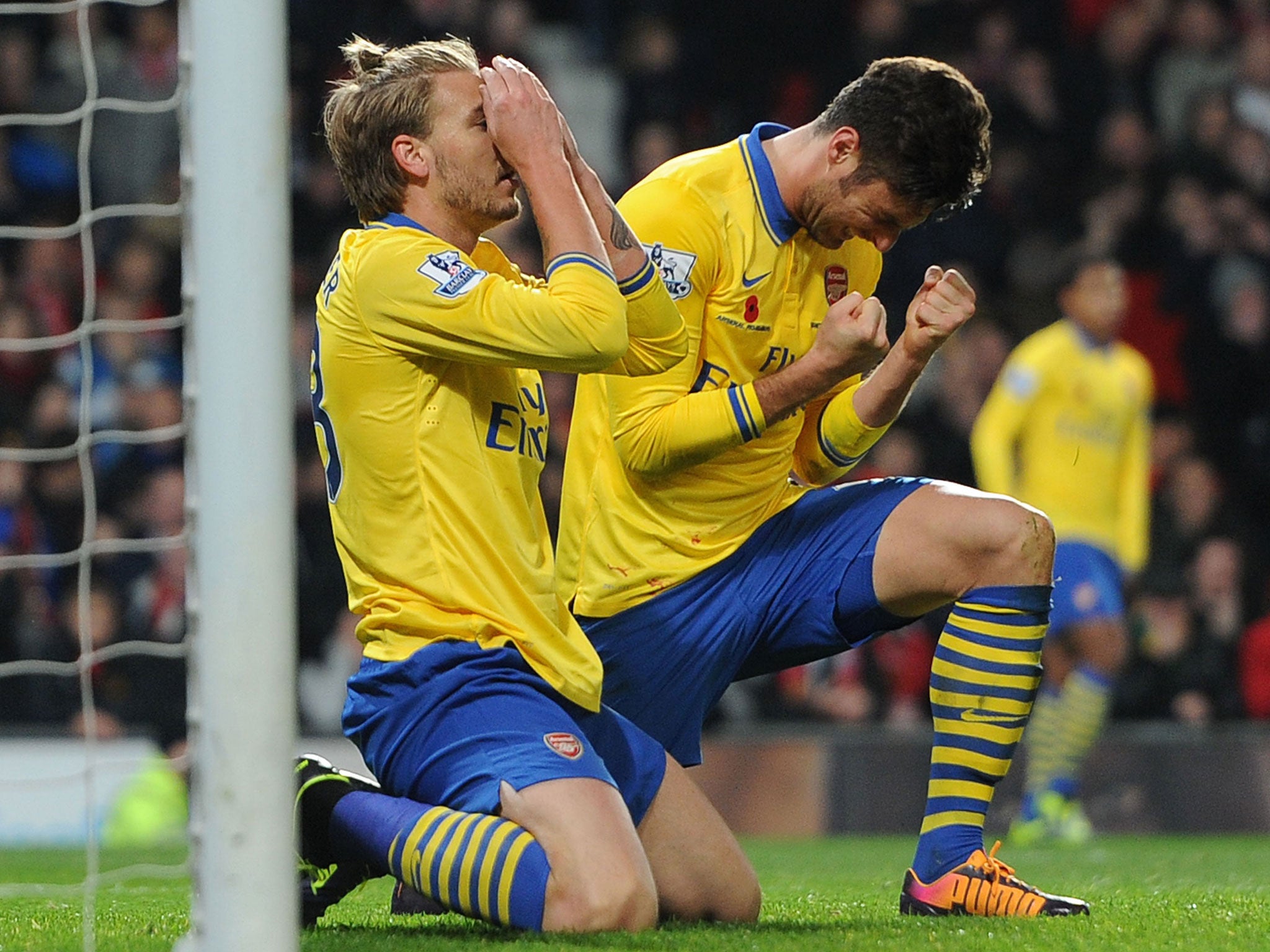 Nicklas Bendtner (left) and Olivier Giroud rue a missed chance in the 1-0 defeat at Manchester United