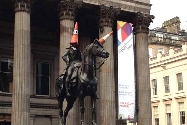 Traffic cones on the the Duke of Wellington monument in Glasgow