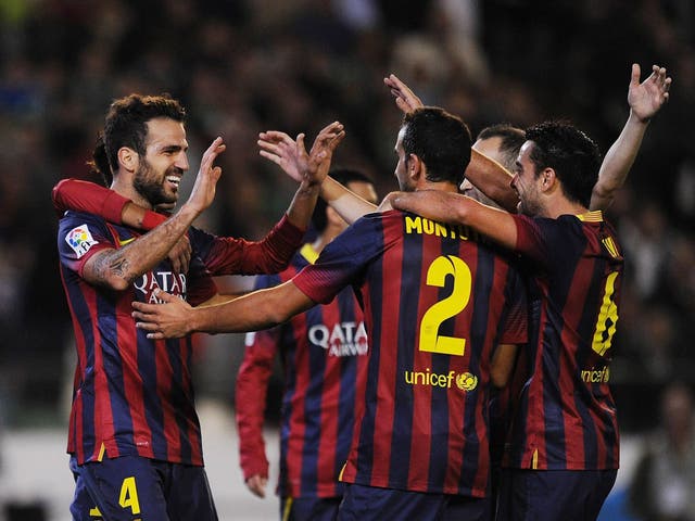 Barcelona players, including Cesc Fabregas, celebrate a goal