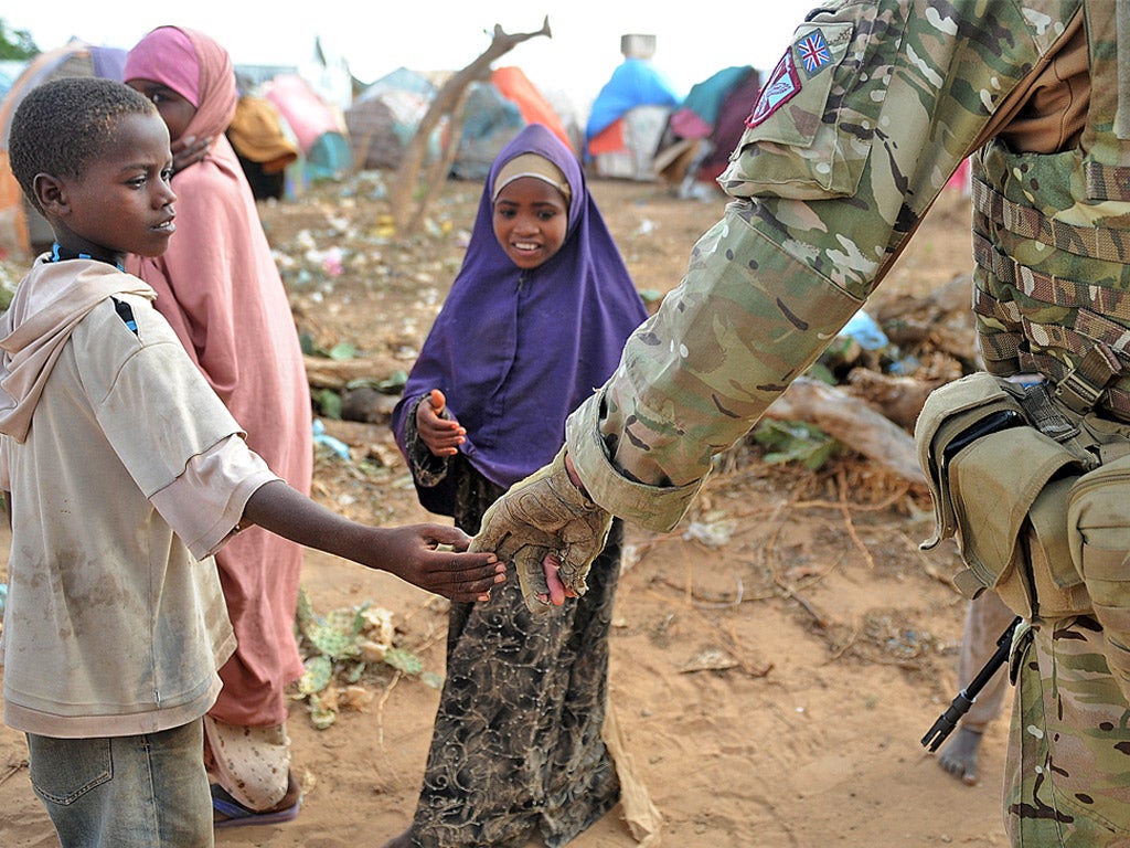 A Somali boy greets a British Army soldier in Afgoye, Somalia (Getty)