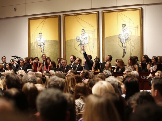 Bidding during the auction for the 1969 painting by Francis Bacon, 'Three Studies of Lucian Freud' in New York