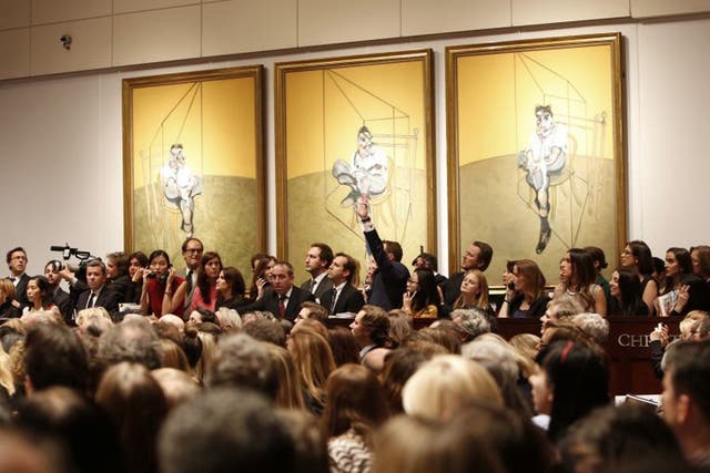 Bidding during the auction for the 1969 painting by Francis Bacon, 'Three Studies of Lucian Freud' in New York