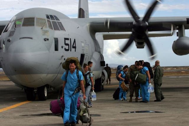 Foreign doctors on board a US C-130 plane arrive to help people affected by typhoon in Tacloban, Leyte, Philippines
