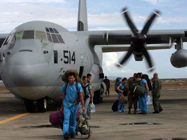 Foreign doctors on board a US C-130 plane arrive to help people affected by typhoon in Tacloban, Leyte, Philippines