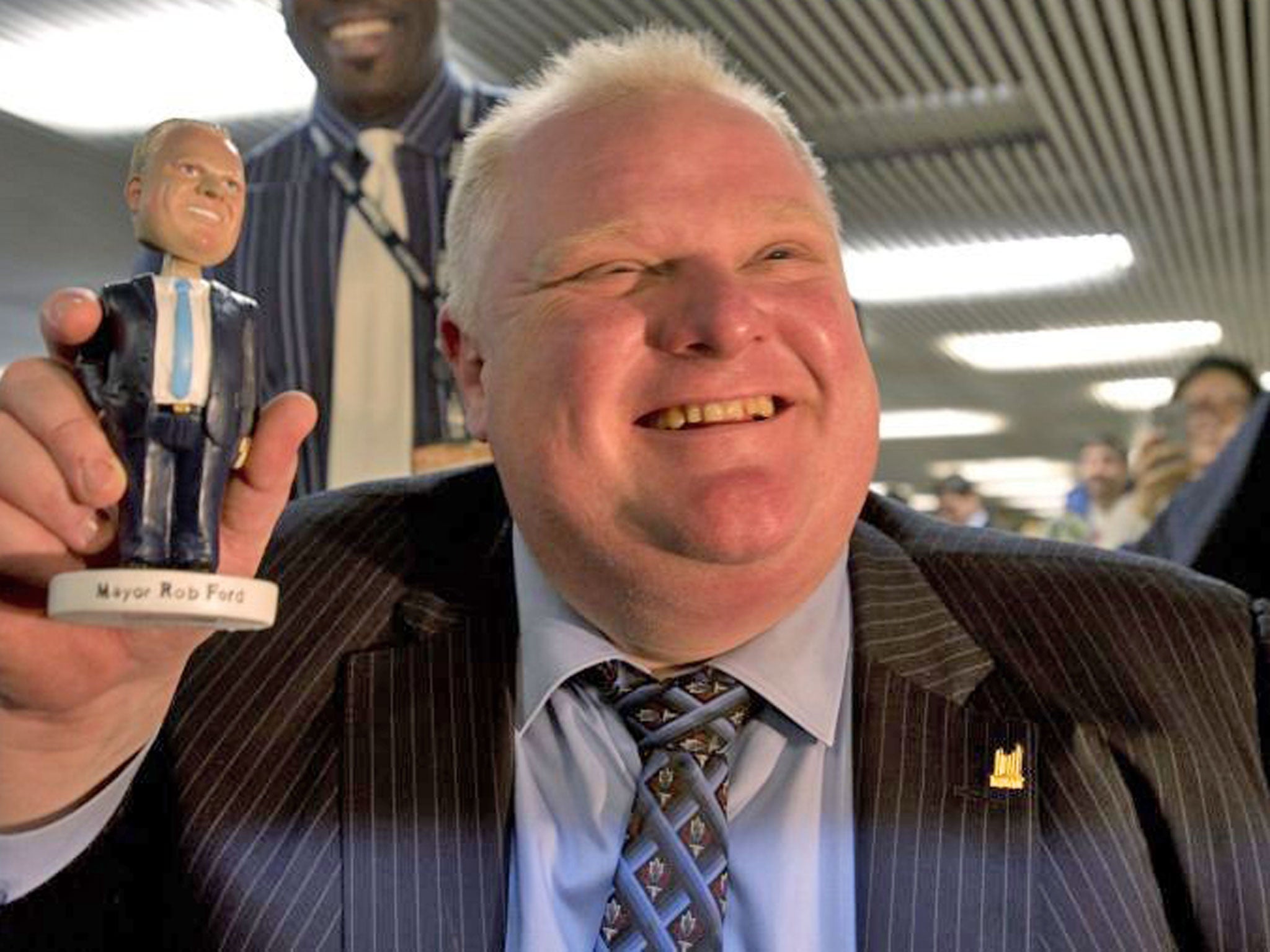 Toronto Mayor Rob Ford holds a Rob Ford bobblehead doll at Toronto city hall
