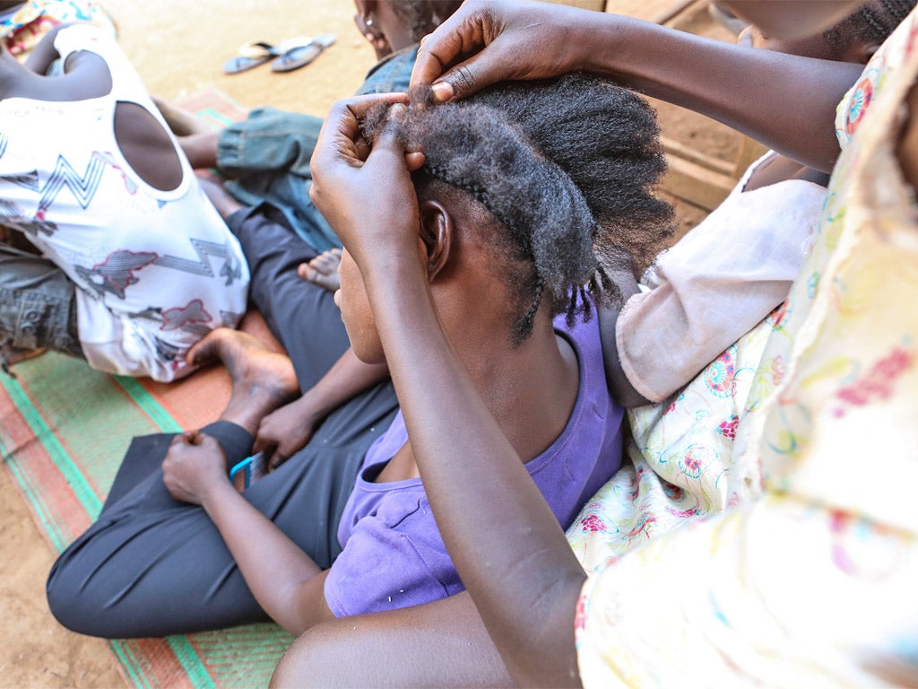 Hair braiding at a Unicef-supported transit station