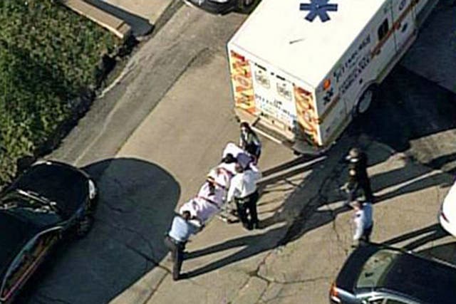 One of the victims is loaded into an ambulance near Brashear High School in Pittsburgh