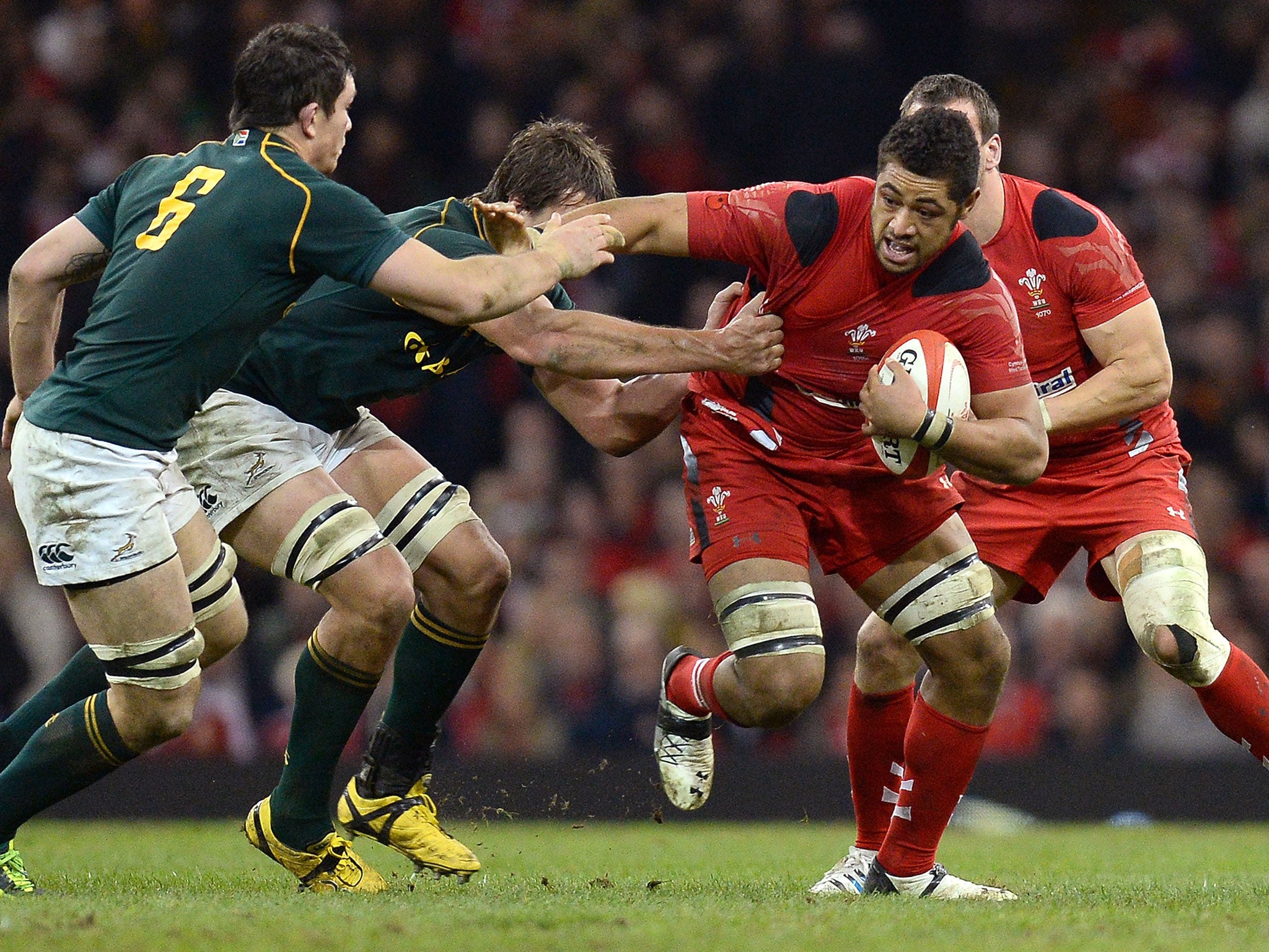 Wales Number Eight Toby Faletau attempts to break the tackle of the South African defence