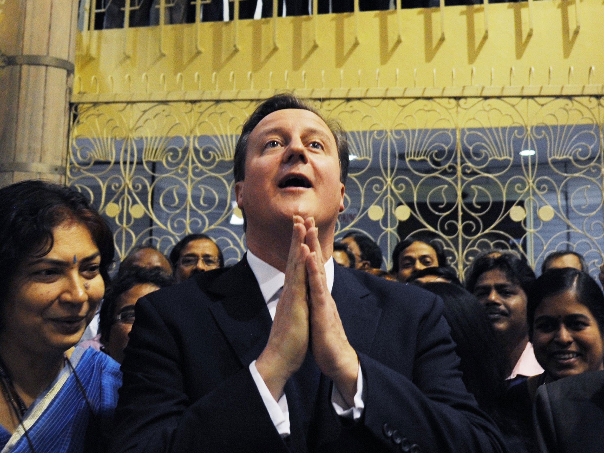 Prime Minister David Cameron meets staff at Air Radio in Kolkata, India, following his interview by the radio station