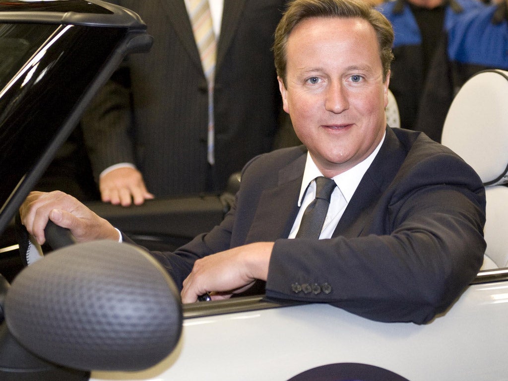 British Prime Minister David Cameron drives the two millionth MINI off the production line in 2011.