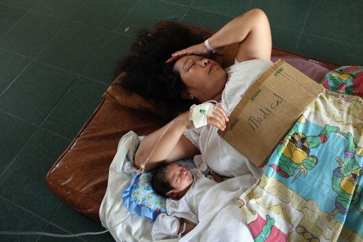 A mother and her infant await medical care after Typhoon Haiyan struck the Philippines