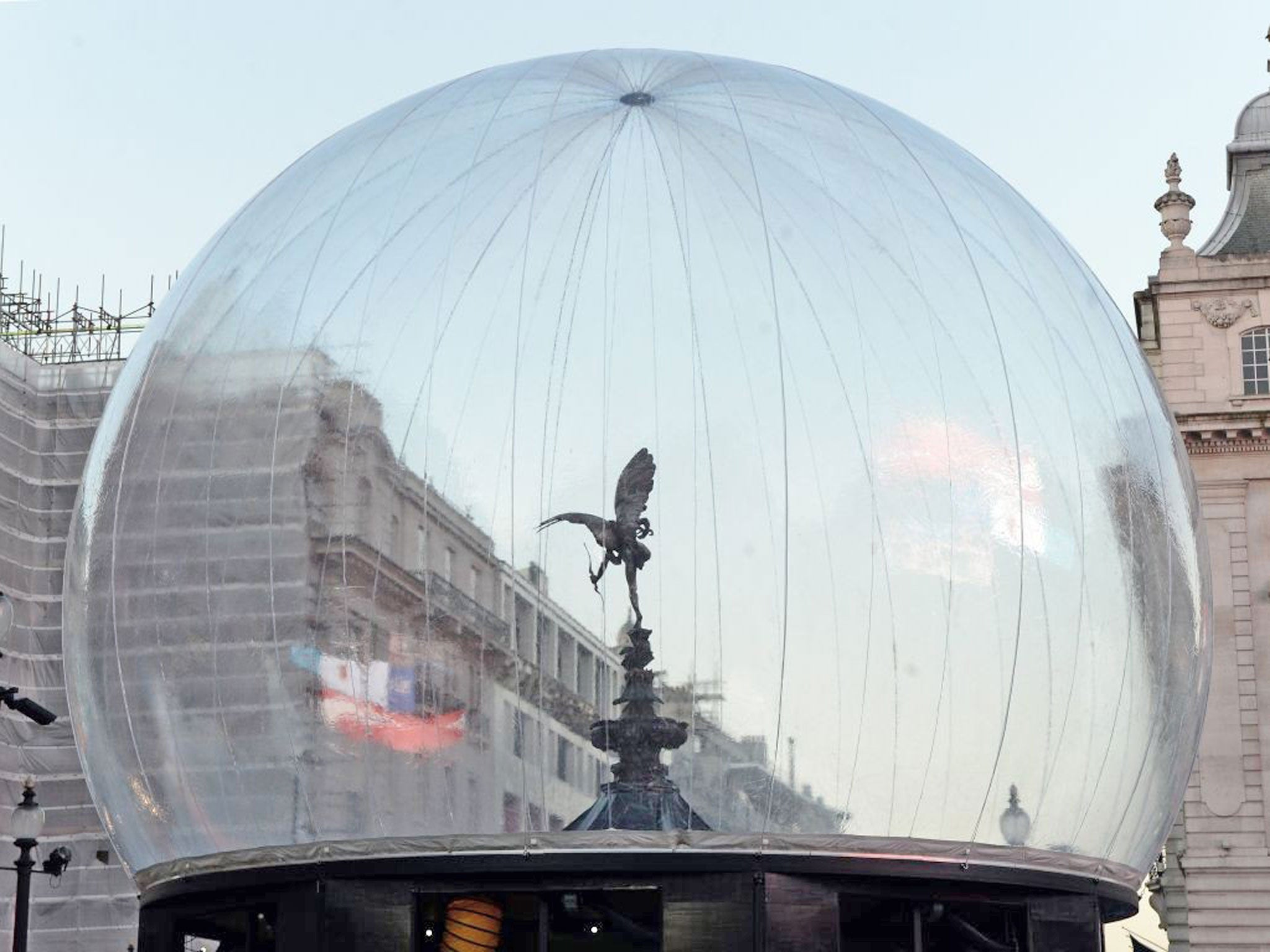 The Eros statue in Picadilly Circus has been transformed into a snow globe. A 30ft PVC membrane has been erected around the figure, which is the Standard's logo, to protect against vandals in the festive season. Fans will blow snowflakes around it