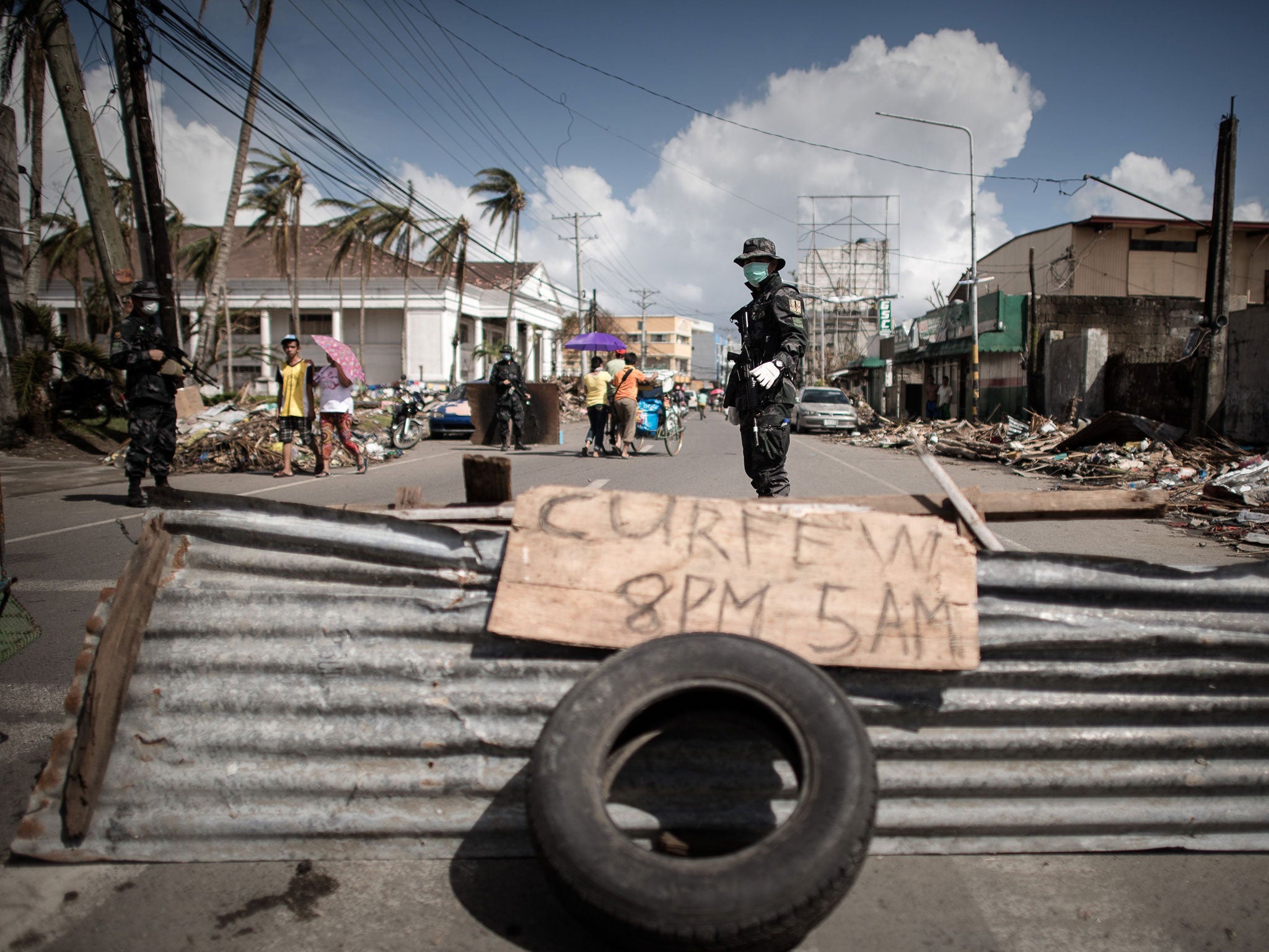 A soldier keeping vigil at a checkpoint in Tacloban, on the eastern island of Leyte. Some 600,000 people have been displaced and the eventual death toll may hit 10,000