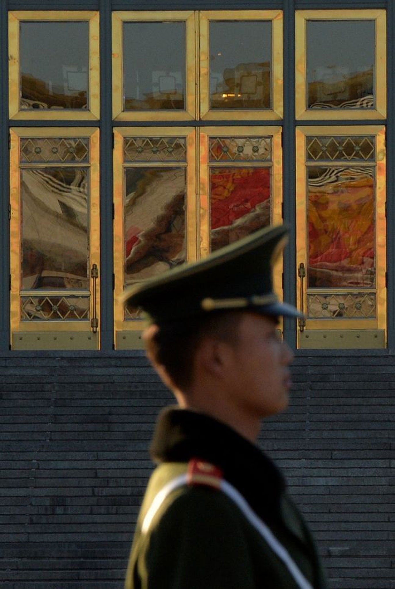 A Chinese paramilitary police officer stands guard in Beijing after the third Plenum