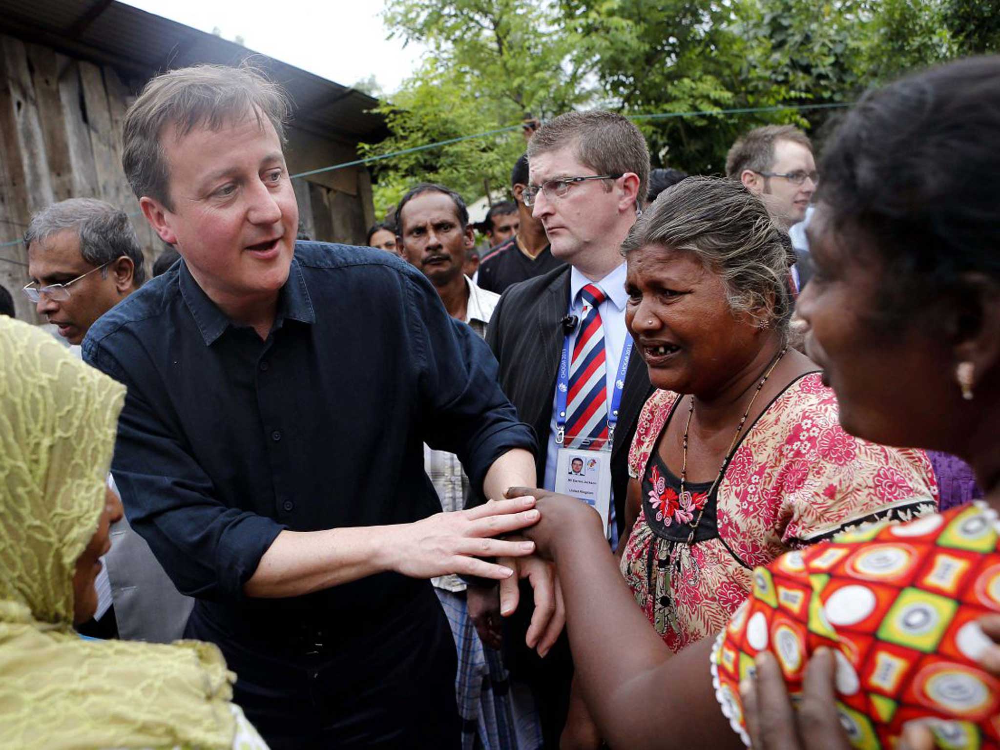 David Cameron talks to villagers of internally displaced peoples camp at Chunnakam village, in Jaffna, northern Sri Lanka on Friday