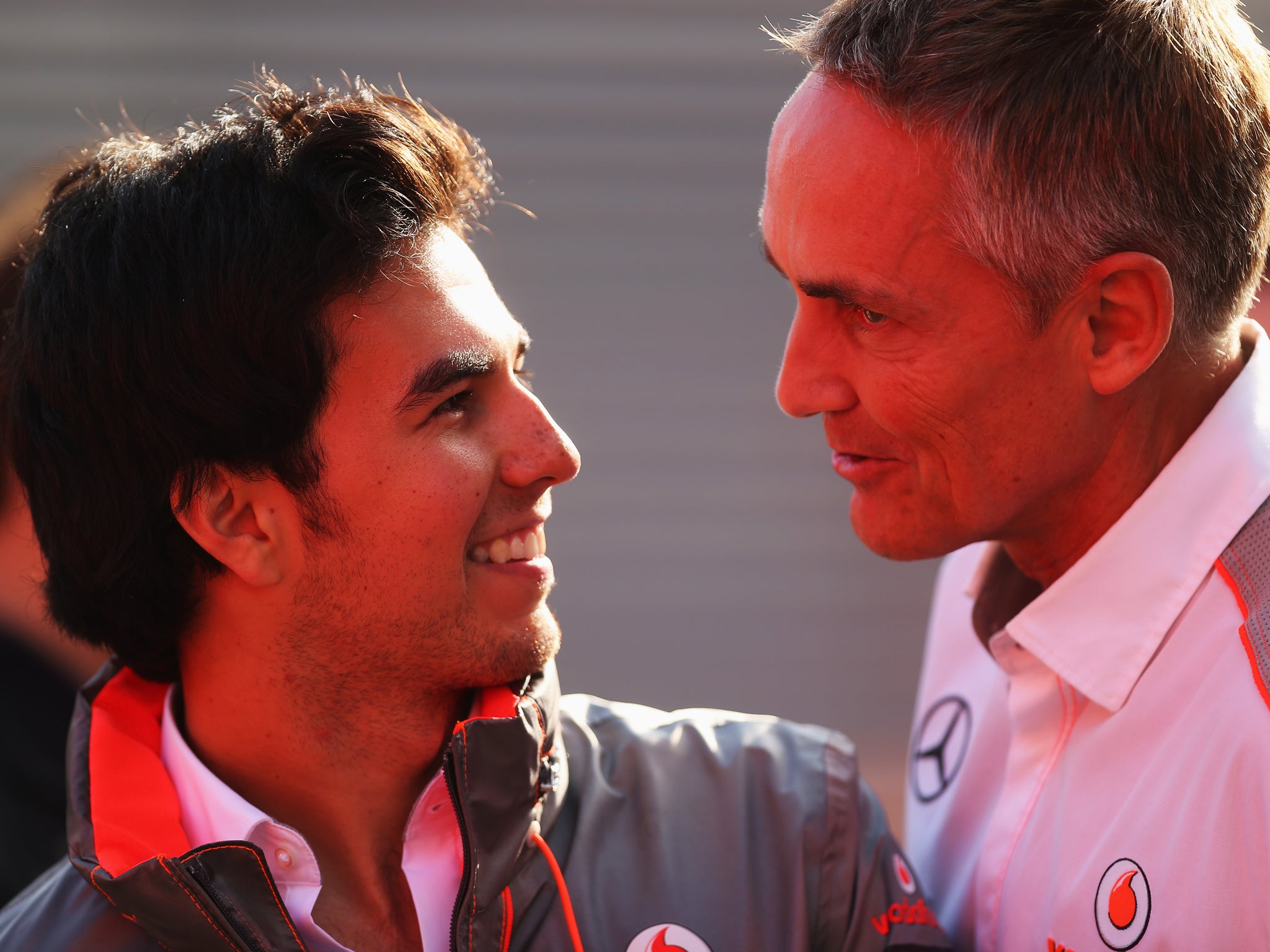 McLaren team principal Martin Whitmarsh (R) has admitted he is doing his utmost to find Sergio Perez (L) a 2014 drive